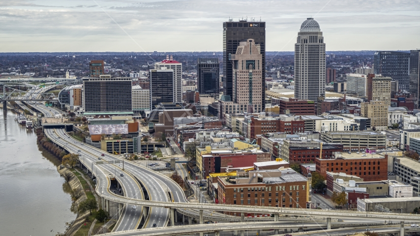 A view of skyscrapers from the riverfront freeway in Downtown Louisville, Kentucky Aerial Stock Photo DXP001_095_0004 | Axiom Images