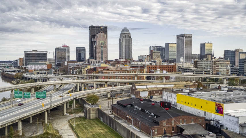 Skyscrapers seen behind freeway on an offramp in Downtown Louisville, Kentucky Aerial Stock Photo DXP001_095_0006 | Axiom Images