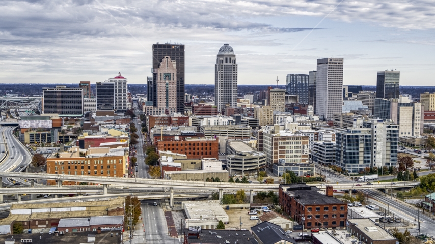 Tall skyscrapers in city skyline behind the freeway ramps in Downtown Louisville, Kentucky Aerial Stock Photo DXP001_095_0007 | Axiom Images