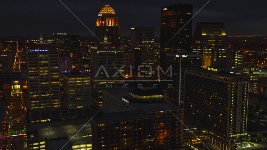 Tall buildings in the city's skyline lit up at twilight, Downtown Louisville, Kentucky Aerial Stock Photo DXP001_096_0022 | Axiom Images