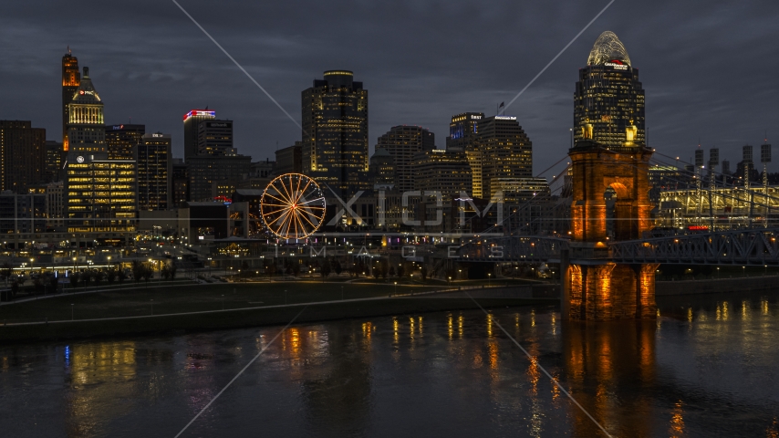 Skyscraper and Ferris wheel at twilight, seen from the Ohio River, Downtown Cincinnati, Ohio Aerial Stock Photo DXP001_098_0012 | Axiom Images