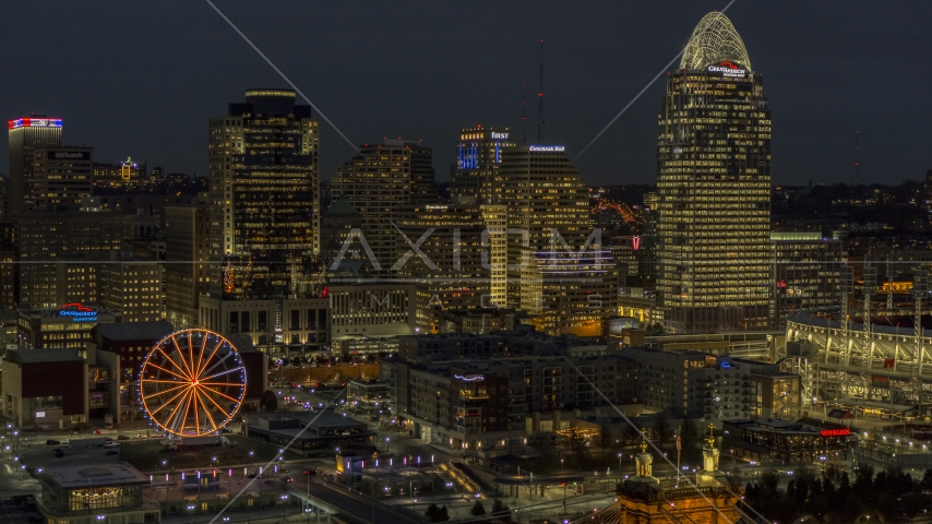 Tall skyscrapers and Ferris wheel at night in Downtown Cincinnati, Ohio Aerial Stock Photo DXP001_098_0018 | Axiom Images