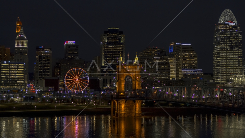 Ferris wheel, Roebling Bridge and city skyline at night, Downtown Cincinnati, Ohio Aerial Stock Photo DXP001_098_0022 | Axiom Images