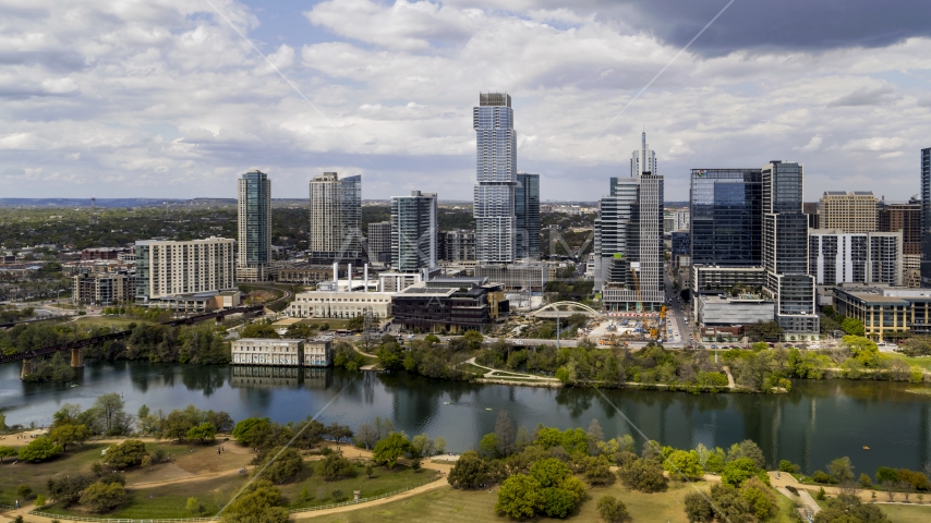 A view of city skyscrapers across Lady Bird Lake, Downtown Austin, Texas Aerial Stock Photo DXP002_102_0011 | Axiom Images