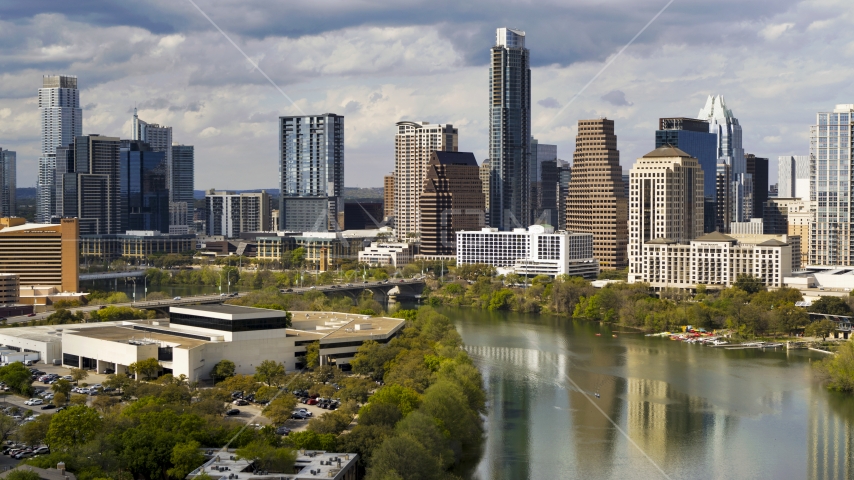 Towering skyscrapers in Downtown Austin, Texas seen from the shore of Lady Bird Lake Aerial Stock Photo DXP002_103_0005 | Axiom Images