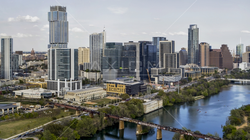 Tall skyscrapers and a bridge spanning Lady Bird Lake, Downtown Austin, Texas Aerial Stock Photo DXP002_104_0003 | Axiom Images