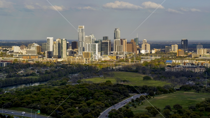 A wide view of city's towering skyline and the shore of Lady Bird Lake, Downtown Austin, Texas Aerial Stock Photo DXP002_104_0008 | Axiom Images