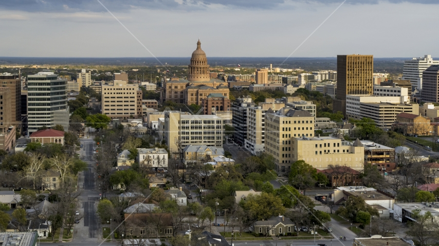 The dome of the Texas State Capitol building at sunset in Downtown Austin, Texas Aerial Stock Photo DXP002_104_0013 | Axiom Images