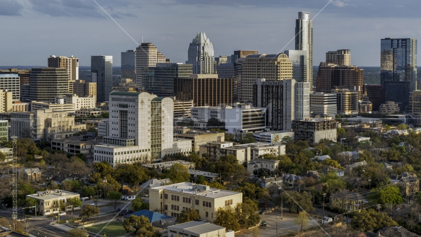 A courthouse and office buildings near skyscrapers at sunset in Downtown Austin, Texas Aerial Stock Photo DXP002_104_0014 | Axiom Images