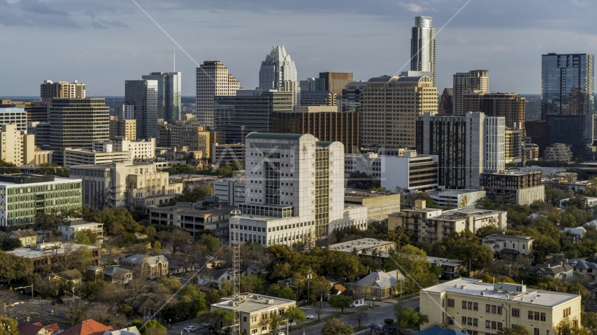 A courthouse near office buildings and skyscrapers at sunset in Downtown Austin, Texas Aerial Stock Photo DXP002_104_0015 | Axiom Images