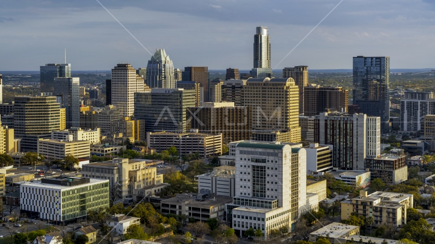 Criminal courthouse near office buildings and skyscrapers at sunset in Downtown Austin, Texas Aerial Stock Photo DXP002_104_0017 | Axiom Images