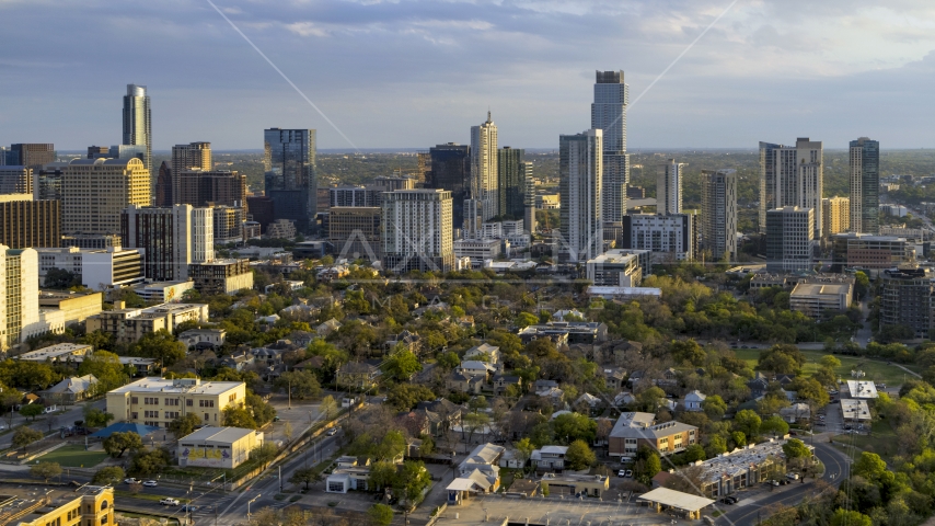 A view of skyscrapers at sunset with clouds in the sky in Downtown Austin, Texas Aerial Stock Photo DXP002_105_0001 | Axiom Images