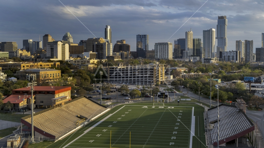 A view of skyscrapers and office buildings at sunset in Downtown Austin, Texas, seen from football stadium Aerial Stock Photo DXP002_105_0002 | Axiom Images