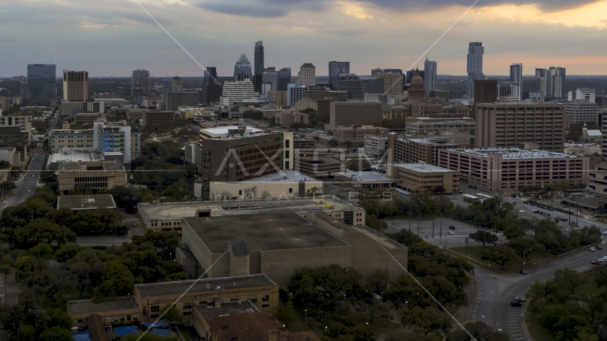 Office buildings and capitol dome at sunset, skyscrapers in background in Downtown Austin, Texas Aerial Stock Photo DXP002_105_0007 | Axiom Images