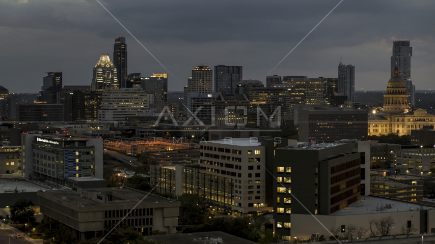 A view of office buildings, skyscrapers near capitol dome at twilight in Downtown Austin, Texas Aerial Stock Photo DXP002_105_0024 | Axiom Images