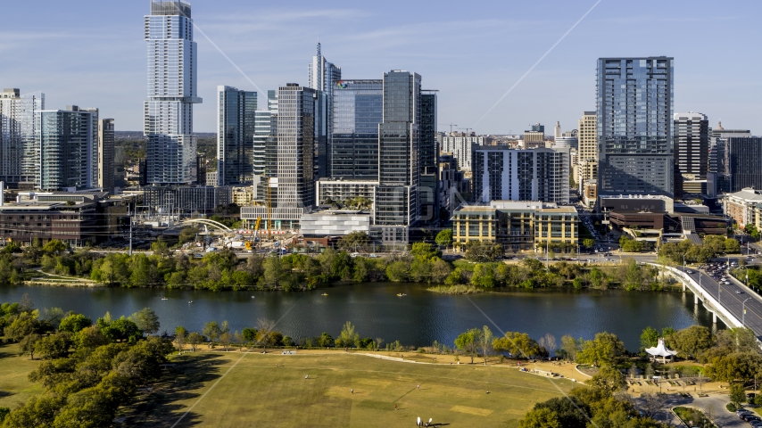 The Northshore skyscraper on the other side of Lady Bird Lake, seen from a park, Downtown Austin, Texas Aerial Stock Photo DXP002_109_0013 | Axiom Images