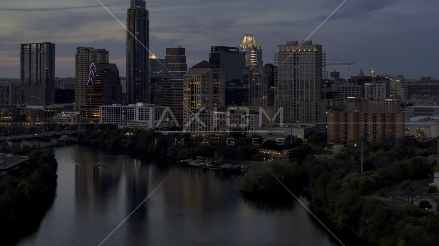 San Jacinto Center beside Lady Bird Lake at twilight in Downtown Austin, Texas Aerial Stock Photo DXP002_110_0019 | Axiom Images