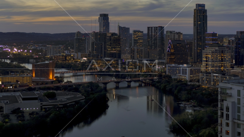 The Congress Avenue Bridge, Lady Bird Lake, skyline at twilight in Downtown Austin, Texas Aerial Stock Photo DXP002_110_0021 | Axiom Images