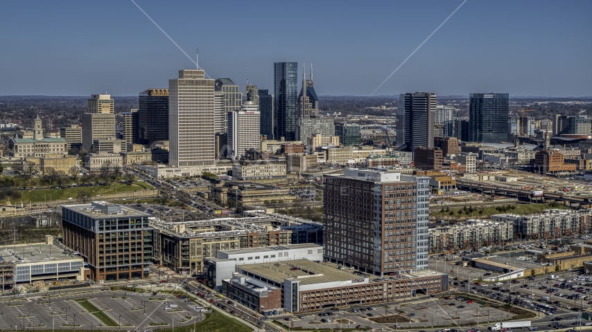 A view of city's skyline behind office and apartment buildings in Downtown Nashville, Tennessee Aerial Stock Photo DXP002_113_0005 | Axiom Images