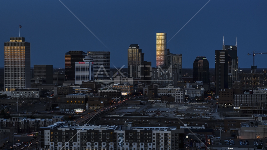 Tall skyscrapers reflecting light in the city skyline at twilight in Downtown Nashville, Tennessee Aerial Stock Photo DXP002_115_0007 | Axiom Images