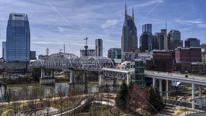 A pedestrian bridge with view of Broadway across the Cumberland River, Downtown Nashville, Tennessee Aerial Stock Photo DXP002_117_0008 | Axiom Images