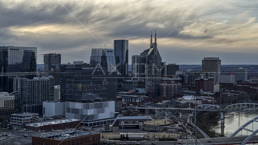 Riverfront skyscrapers by the Cumberland River at sunset, Downtown Nashville, Tennessee Aerial Stock Photo DXP002_120_0002 | Axiom Images