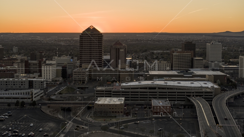 Sunset behind office tower and shorter hotel tower, Downtown Albuquerque, New Mexico Aerial Stock Photo DXP002_122_0009 | Axiom Images