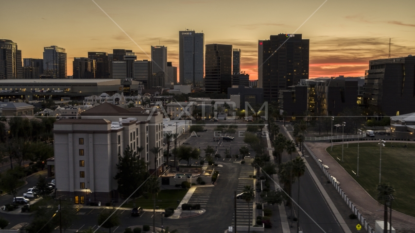 A view of tall office high-rises at sunset in Downtown Phoenix, Arizona Aerial Stock Photo DXP002_139_0003 | Axiom Images