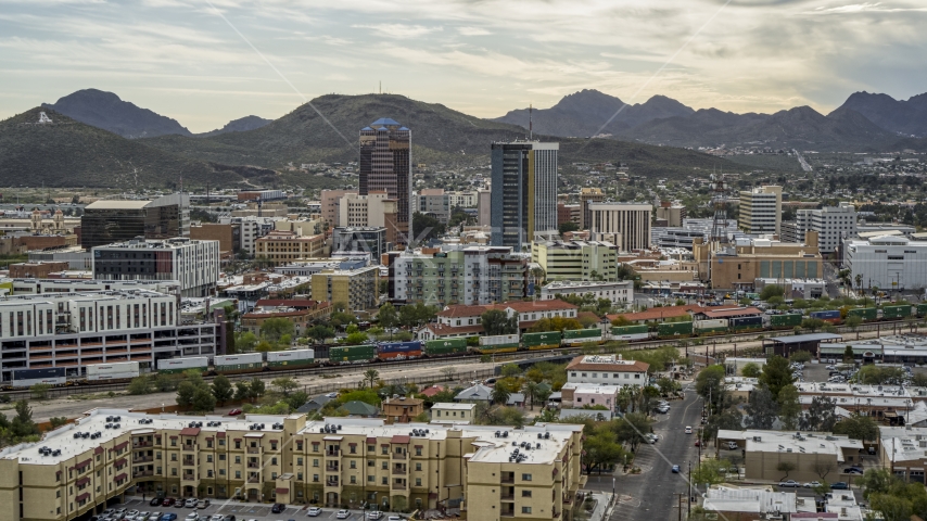 Office towers as a train passes, with Sentinel Peak in the background, Downtown Tucson, Arizona Aerial Stock Photo DXP002_145_0009 | Axiom Images