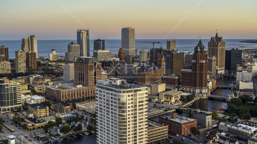 City buildings and skyscrapers seen from Milwaukee River at twilight, Downtown Milwaukee, Wisconsin Aerial Stock Photo DXP002_150_0003 | Axiom Images