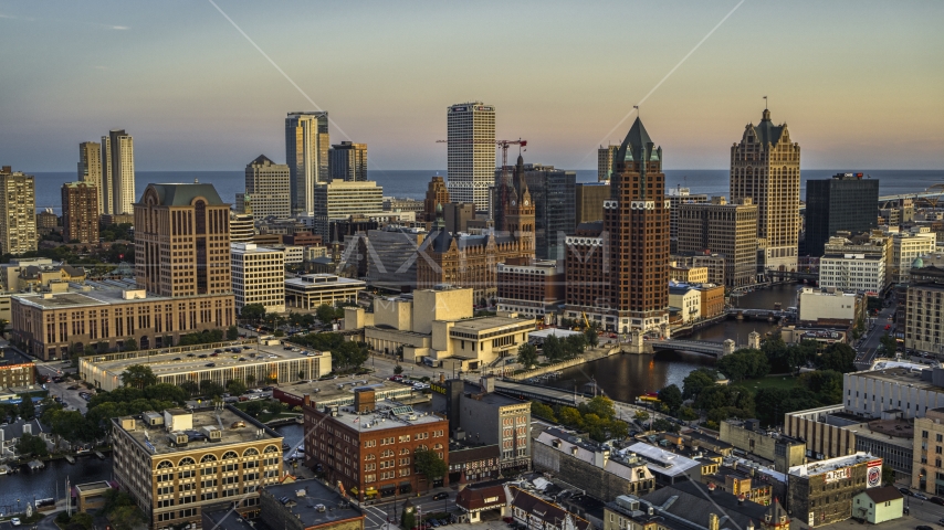 A view of city buildings and skyscrapers seen from Milwaukee River at twilight, Downtown Milwaukee, Wisconsin Aerial Stock Photo DXP002_150_0004 | Axiom Images