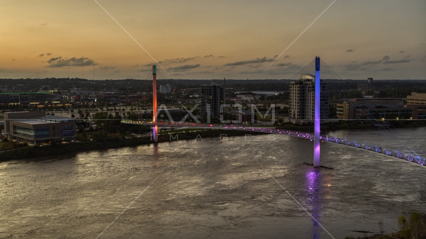 A colorful pedestrian bridge spanning the Missouri River at twilight, Omaha, Nebraska Aerial Stock Photo DXP002_172_0017 | Axiom Images