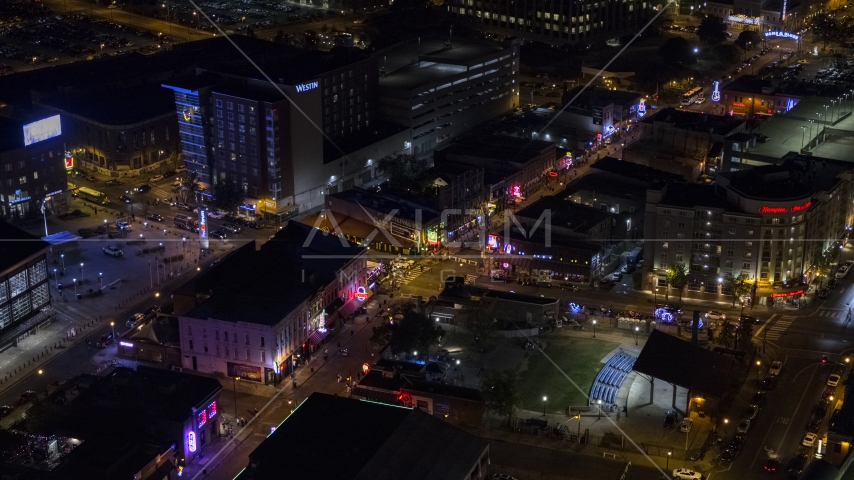 Bright lights and signs down Beale Street at nighttime, Downtown Memphis, Tennessee Aerial Stock Photo DXP002_188_0001 | Axiom Images