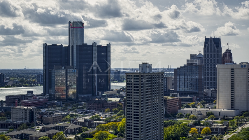 GM Renaissance Center overlooking the river behind apartment high-rise in Downtown Detroit, Michigan Aerial Stock Photo DXP002_194_0007 | Axiom Images