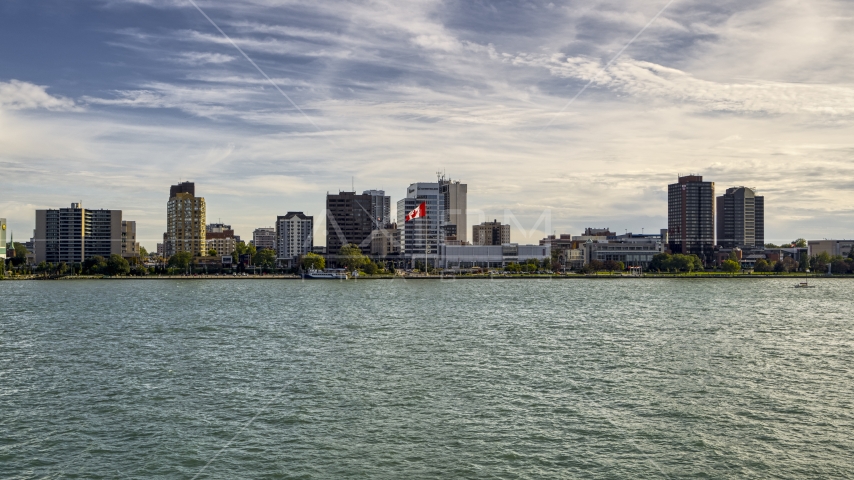 Office buildings and Canadian flag by the river in Windsor, Ontario, Canada Aerial Stock Photo DXP002_196_0003 | Axiom Images