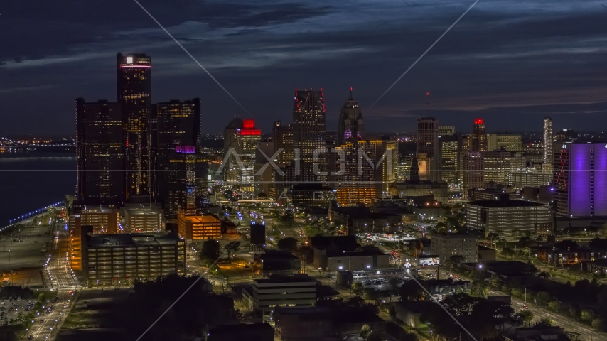 The brightly lit city skyline at twilight in Downtown Detroit, Michigan Aerial Stock Photo DXP002_198_0004 | Axiom Images