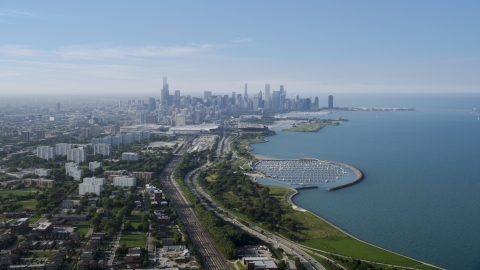 AX0001_013.0000472F - Aerial stock photo of The Downtown Chicago skyline in the distance, Illinois