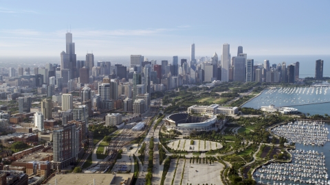 AX0001_019.0000107F - Aerial stock photo of Soldier Field and Downtown Chicago skyline, Illinois