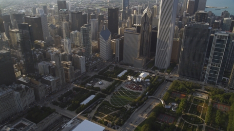 AX0001_103.0000270F - Aerial stock photo of Cloud Gate sculpture and Jay Pritzker Pavilion in Grant Park, Downtown Chicago, Illinois