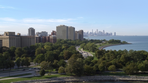 AX0002_003.0000257F - Aerial stock photo of Hyde Park apartment buildings, and the Downtown Chicago skyline, Illinois