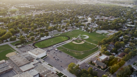 AX0003_001.0000193F - Aerial stock photo of Thornton Fractional South High School at sunset, Lansing, Illinois