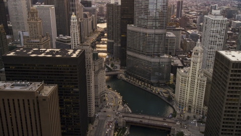 AX0003_037.0000286F - Aerial stock photo of The Chicago River and the base of Trump Tower at sunset, Downtown Chicago, Illinois