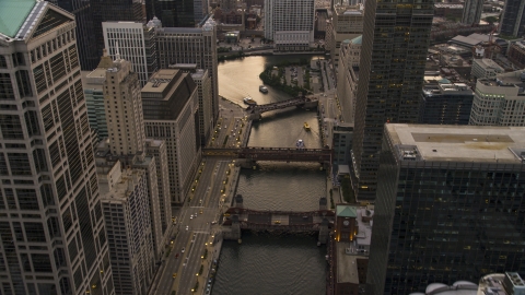 AX0003_039.0000226F - Aerial stock photo of Bridges spanning the Chicago River through downtown at sunset, Downtown Chicago, Illinois