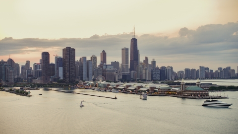 AX0003_064.0000424F - Aerial stock photo of Navy Pier and the Downtown Chicago skyline on a cloudy day at sunset, Illinois