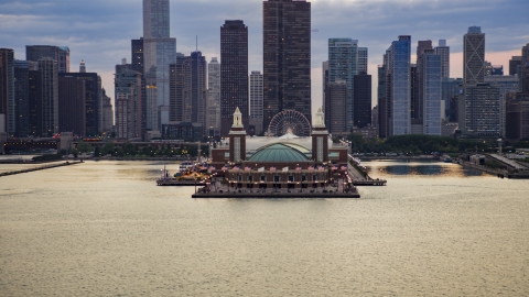 Navy Pier with Downtown Chicago skyscrapers behind it on a cloudy day at sunset, Illinois Aerial Stock Photos | AX0003_066.0000089F