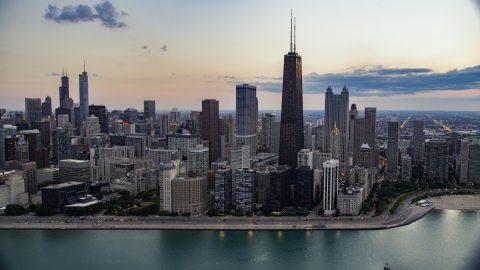 AX0003_069.0000258F - Aerial stock photo of John Hancock Center and Downtown Chicago skyscrapers on a cloudy day at twilight, Illinois