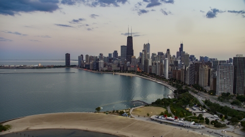 AX0003_073.0000132F - Aerial stock photo of The skyline of Downtown Chicago seen from North Avenue Beach at twilight, Illinois