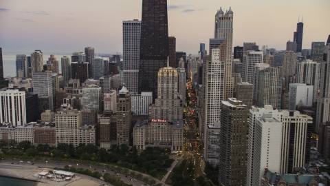 AX0003_075.0000318F - Aerial stock photo of The Drake Hotel by John Hancock Center at twilight, Downtown Chicago, Illinois