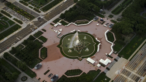 AX0003_082.0000264F - Aerial stock photo of Buckingham Fountain at twilight in Grant Park, Downtown Chicago, Illinois