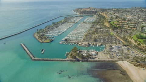 AX0159_188.0000000 - Aerial stock photo of Breakwaters around Dana Point Harbor by seaside neighborhoods in Dana Point, California